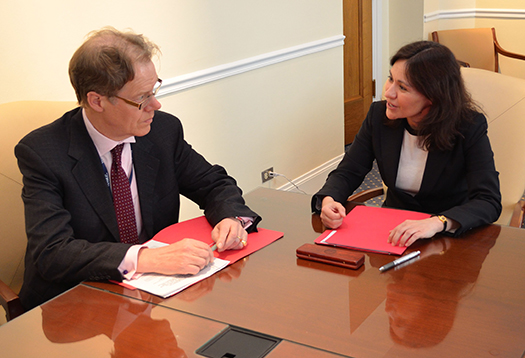 FTC Chairwoman Edith Ramirez and UK Information Commissioner Christopher Graham seated at a table speaking with each other