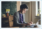 man typing on computer