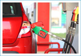 car at gas station with gas pump attached