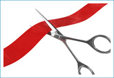 scissors cutting a red ribbon