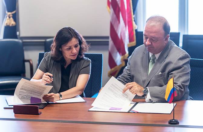 Chairwoman Ramirez signs the Memorandum of Understanding with Ambassador Villegas participating.